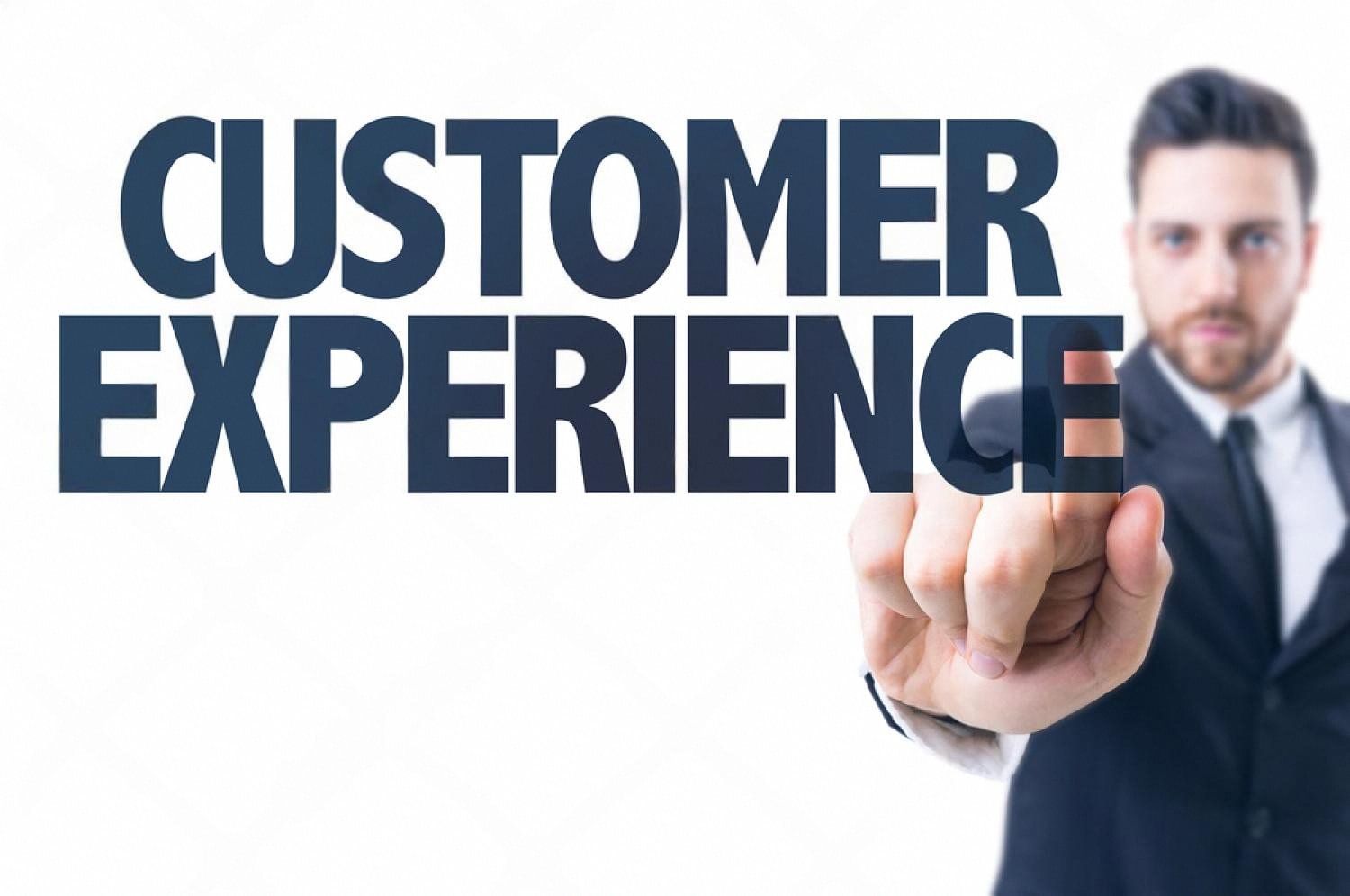 Businessman pointing at the words Customer Experience, representing CX trends for UAE businesses